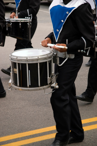close up of snare drum player in marching band