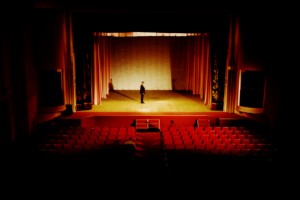 Empty opera hall one man on stage
