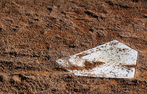 close up shot of a homeplate in a mound of dirt