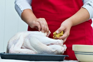 Woman stuffing a turkey