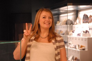 donna giving peace sign in from of mineral gallery display