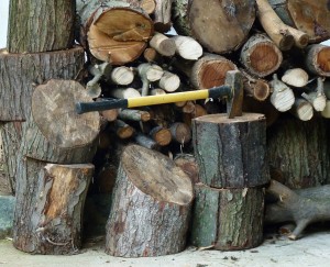 pile of wood with axe in one of the pieces