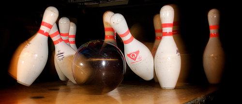 bowling ball knocking down four pins