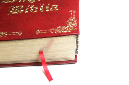 red spanish bible with bookmark ribbon hanging out