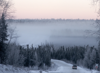 winter winding road in alaska mountains