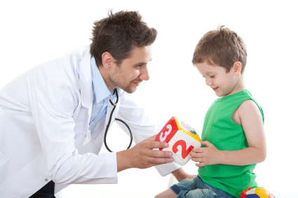 young male pediatrician with boy holding block