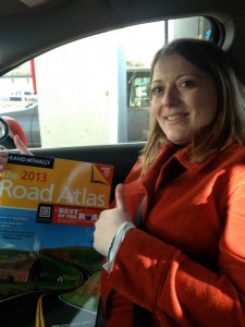 donna talarico in car holding atlas with thumbs up