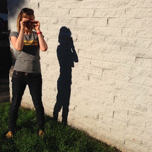 Kirsten voris standing by wall with shadow