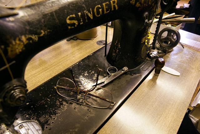 Sewing machine with mans glasses