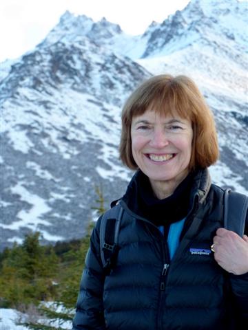 susan pope hiking with mountains behind her