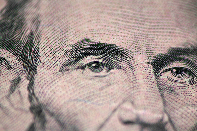 Close up of five dollar bill lincolns eyes