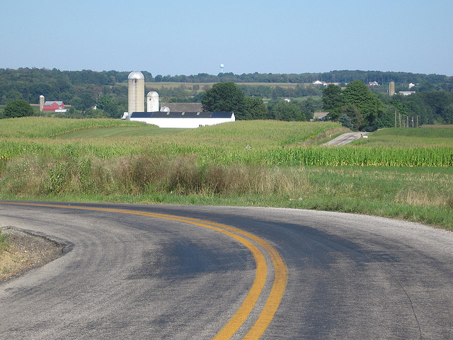 Rural ohio road curve with farm in backgroud