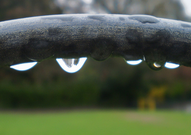 water dripping on an iron fence - close-up