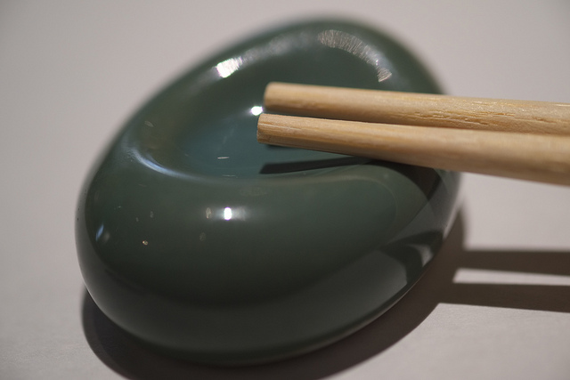 Chopsticks sitting on small ceramic bowl