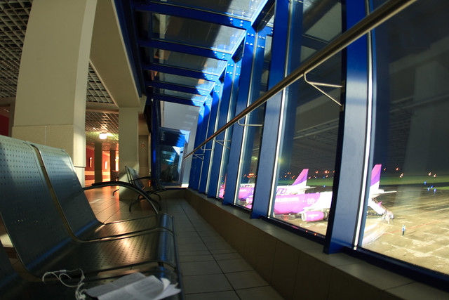Empty airline gate waiting area at night planes lined up outside window