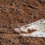close up shot of a homeplate in a mound of dirt
