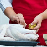 woman stuffing a turkey