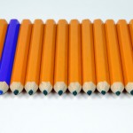 row of yellow pencils with one blue pne