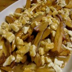 plate of poutine, canadian fries with gravy and cheese curds