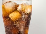 glass of cola with ice and lots of bubbles
