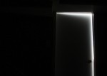 closed door in dark with light coming through edges