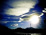 sun shining through clouds in blue sky in colorado