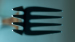 close up of fork and its bigger shadow