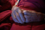 old man hands on stomach, folded