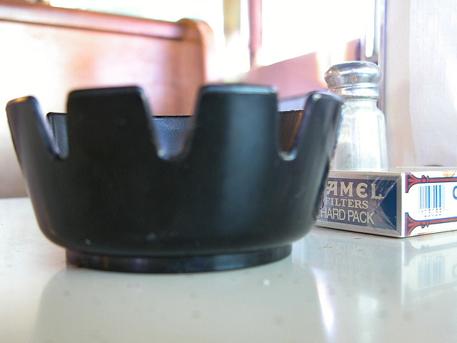 ash tray on diner table with salt and paper in background