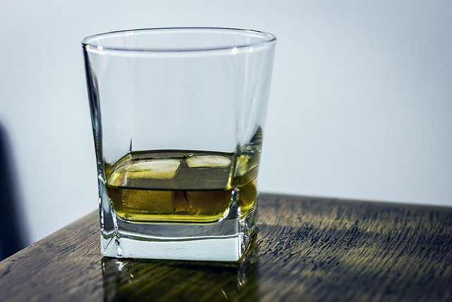whiskey on glass on wooden table