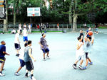 crowd of younger adults and teens playing basketball, several races together