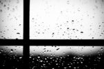 close-up of window with rain drops; window pane left of center