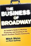 business of broadway written inside of a briefcase with authors names beneath