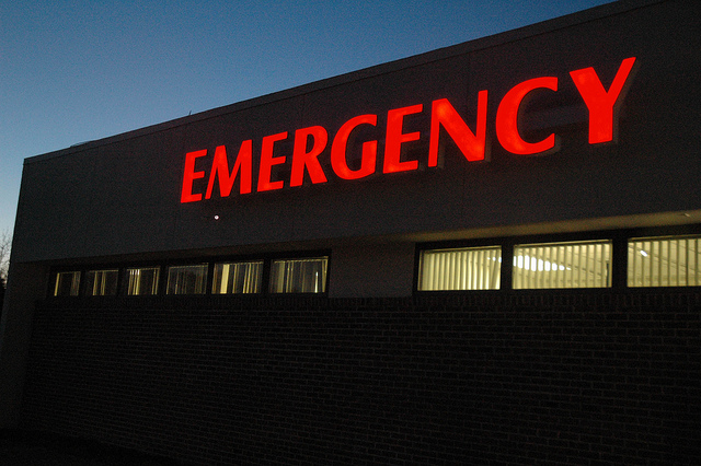 red lit-up emergency sign on hospital exterior