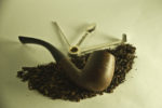 pipe, tobacco, cutters and other supplies on table