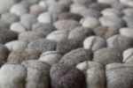 close-up shot of small cotton wool balls in gray and offwhite