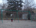 child on swing on swing set
