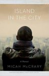 cover of island in the city; close up of back of african american male looking down to the city