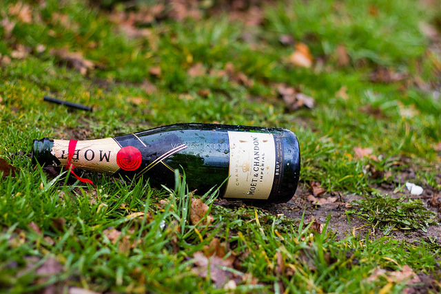 empty champagne bottle in the grass