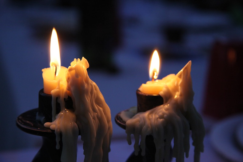 two Sabbath candles flickering, burned almost to the end