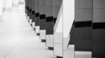 a line of tall mirrors - abstract