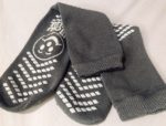 pair of hospital socks with tread on the bottom, including a smiley face