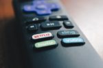 remote control with buttons for apps, including netflix