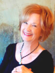 Headshot of author Rebecca McClanahan. The author is smiling , wearing a beaded necklace and black shirt.