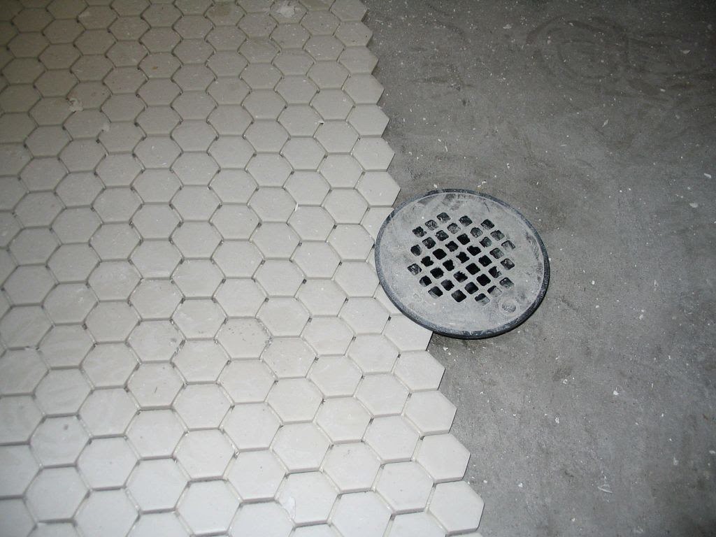 shower drain on tile and cement floor
