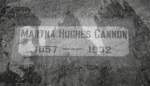 martha hughes cannon's grave stone with both the mormon temple and image of marie blurred in background, almost shadows