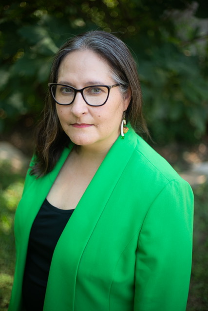 Portrait of author ursula pike in bright green jacket