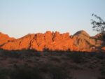 red rocky ridge with desert in forefront