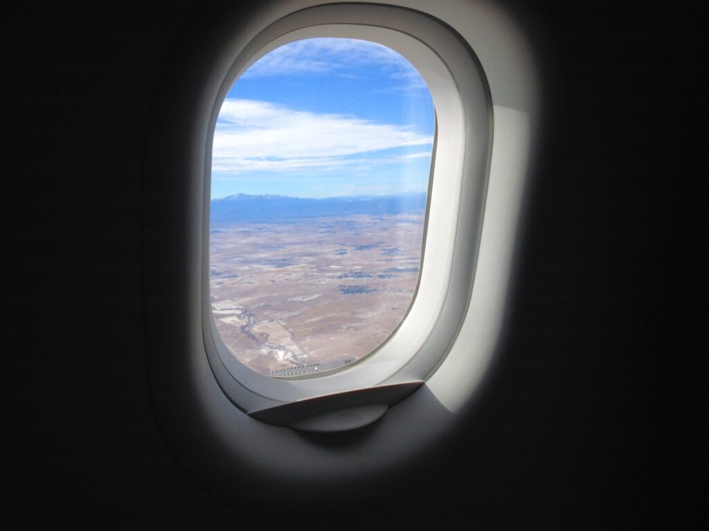 Airplane window looking out to desert