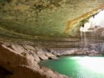rocky cavern with pool of greenish water